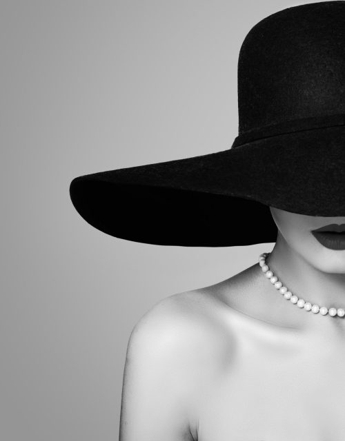 Elegant woman in classic hat, retro black and white portrait